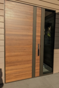 Design In Wood built not only the teak-faced entry door, but the entire powder-coated steel and glass surround. Design concept, Ruth Livingston Interior Design.