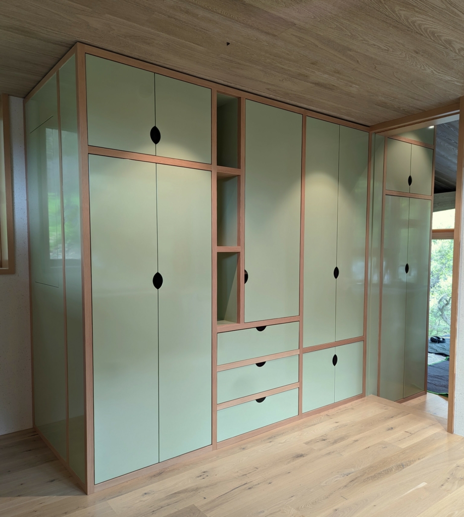 Storage wall of closet and display cabinetry. High gloss CV paint is combined with natural VG fir for a playful, contemporary look.