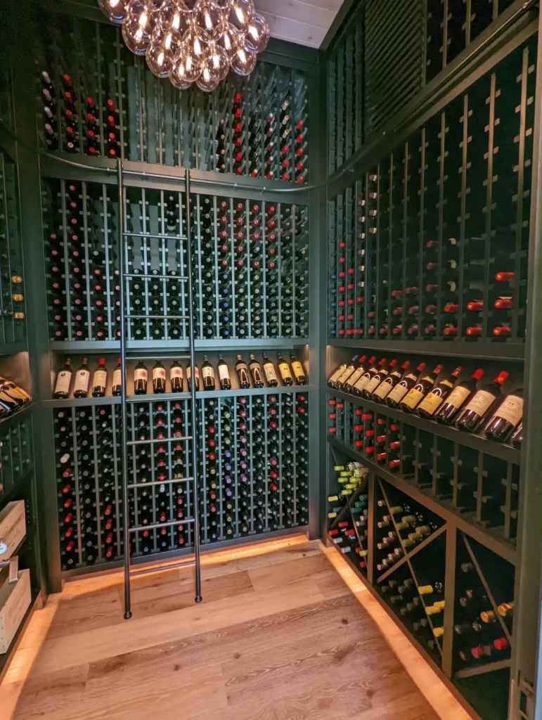 Wine cellar boasts a custom rolling ladder system from Germany. Maximum storage in a small space. Design in Wood, Petaluma, CA